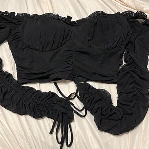 Off the shoulder cropped long sleeve shirt.